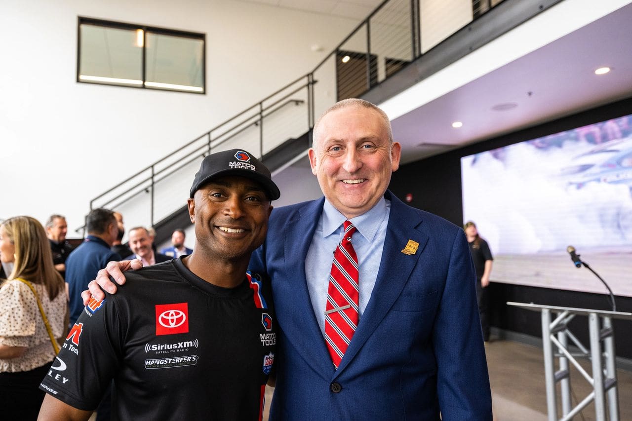 Antron Brown (left), a PRI member and NHRA Top Fuel owner-driver, enjoys the grand-opening celebration of the PRI Membership Headquarters with PRI President Dr. Jamie Meyers. (Photo courtesy of PRI)