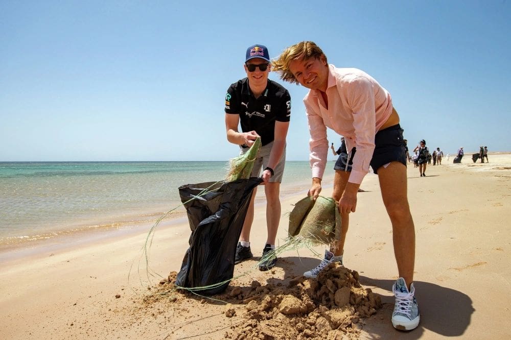 Eventual event winners Johan Kristoffersson (left) and team owner Nico Rosberg (right) pick up litter from a Saudi Arabian beach a few days before the Extreme E debut there at Al-'Ula. Environmental responsibility is a hallmark of the dramatically different motorsport series. So, Kristoffersson's driving partner Molly Taylor was proud to tout, is gender equality. Each team has two drivers, one man and one woman, who make a lap each in the two-lap format. (Photo by Colin McMaster, courtesy of Extreme E Series). 