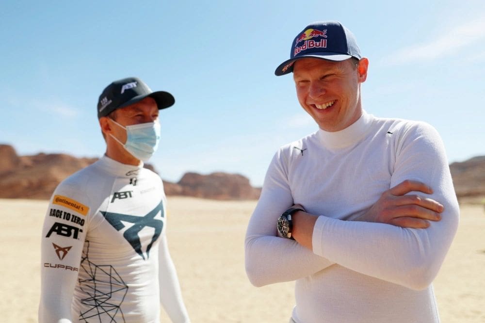 Johan Kristoffersson (right), whose Rosberg X team won the first-ever Extreme E Series trophy April 4 at Al-'Ula, Saudi Arabia, shared a light-hearted moment before racing began with fellow Swede Mattias Ekstrom (left). (Photo by Sam Bloxham, courtesy of Extreme E Series)