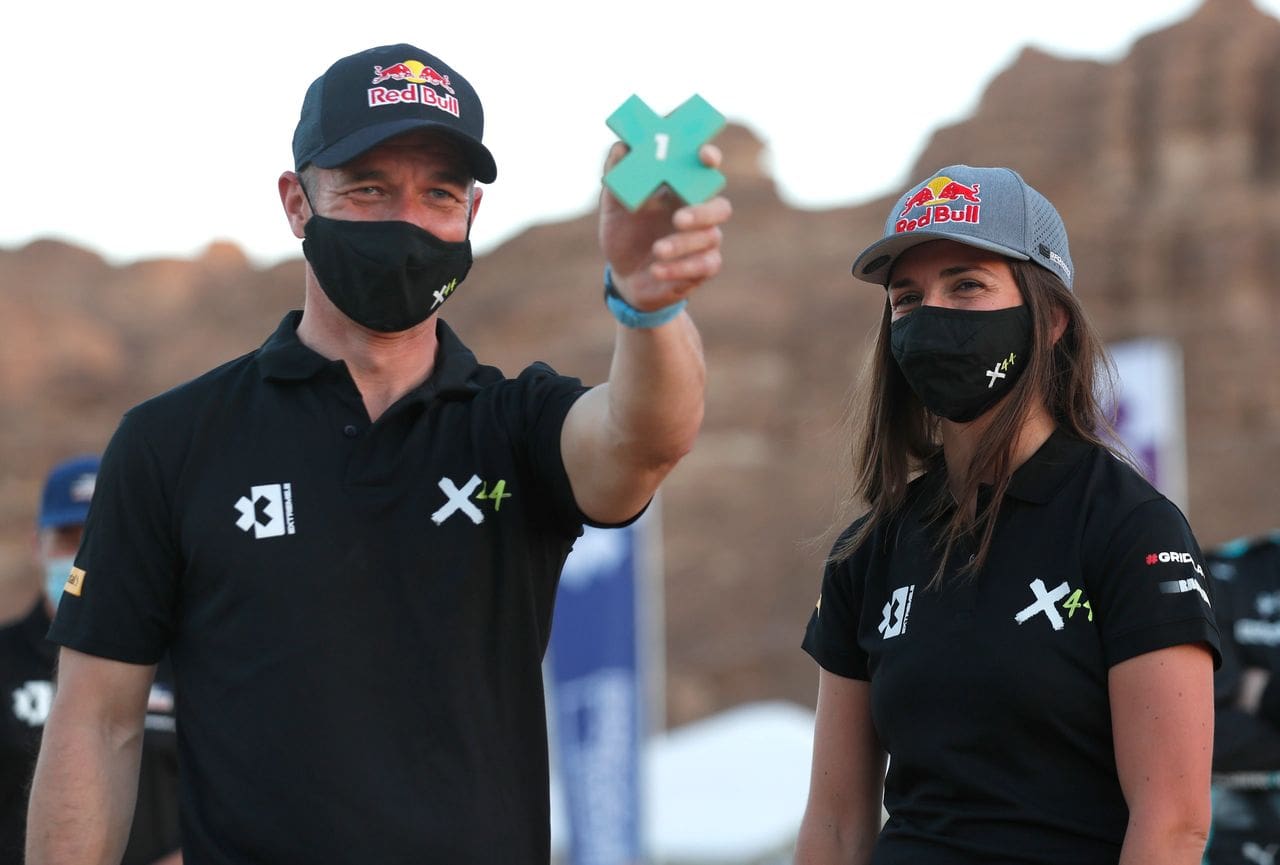 Sebastien Loeb and Cristina Gutiérrez celebrate their No. 1 qualifying achievement after Day 1 action at the Desert X Prix, the first Extreme E Series in the Saudi Arabian desert. Their team owner is Formula 1 dominator Lewis Hamilton. (Photo courtesy of Extreme E)  